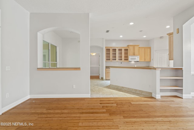 2305 Range Crescent Ct, Fleming Island, FL 32003 - unfurnished living room featuring arched walkways, light wood-style floors, recessed lighting, and baseboards