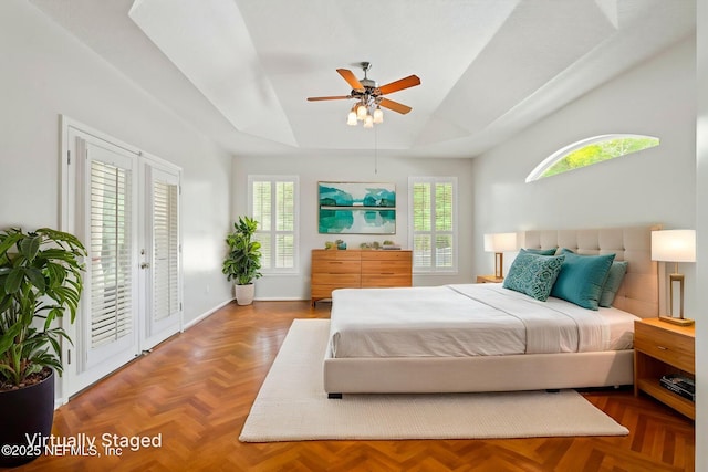 2305 Range Crescent Ct, Fleming Island, FL 32003 - bedroom with access to outside, multiple windows, a tray ceiling, and ceiling fan
