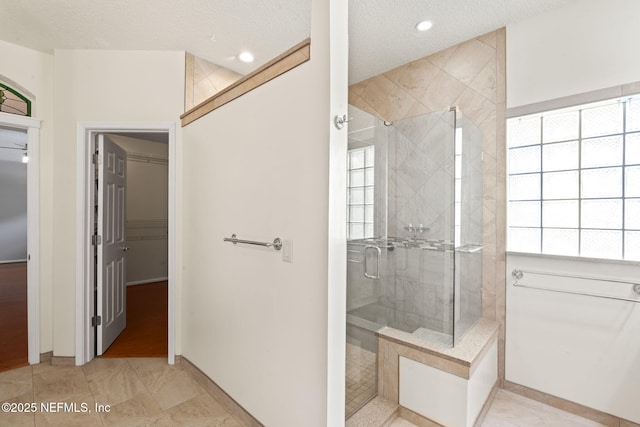 2305 Range Crescent Ct, Fleming Island, FL 32003 - bathroom featuring tiled shower, baseboards, a textured ceiling, and recessed lighting