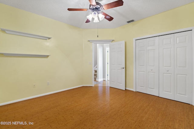 2305 Range Crescent Ct, Fleming Island, FL 32003 - unfurnished bedroom featuring a closet, wood finished floors, a ceiling fan, and baseboards