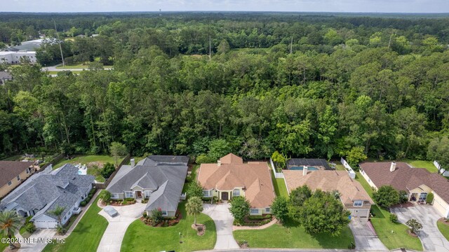 2305 Range Crescent Ct, Fleming Island, FL 32003 - aerial view of property and surrounding area featuring a heavily wooded area and nearby suburban area