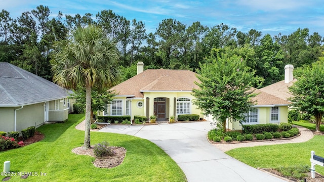 2305 Range Crescent Ct, Fleming Island, FL 32003 - view of front of home with a chimney, a front lawn, stucco siding, driveway, and a shingled roof