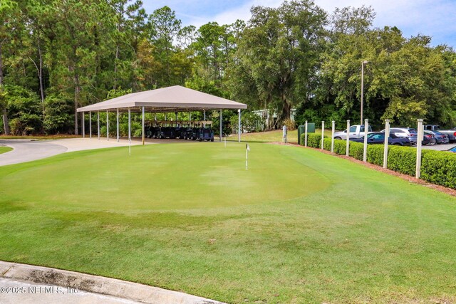 2305 Range Crescent Ct, Fleming Island, FL 32003 - view of property's community with a putting green, golf course view, a detached carport, and view of wooded area