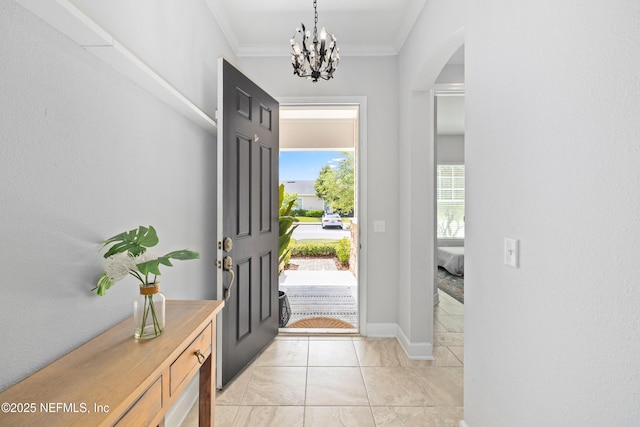 80 Atlas Dr, Saint Augustine, FL 32092 - foyer entrance featuring arched walkways, crown molding, a chandelier, baseboards, and light tile patterned floors