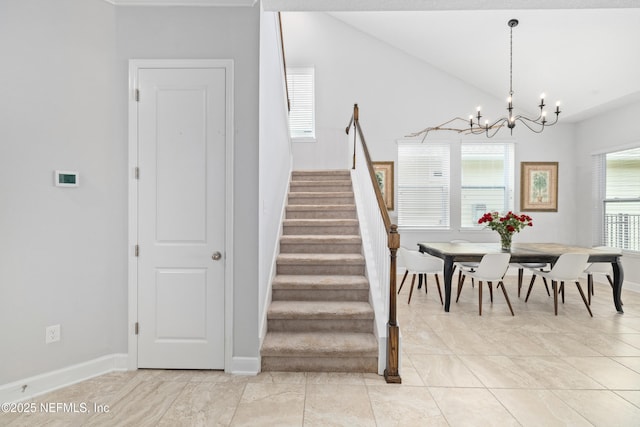 80 Atlas Dr, Saint Augustine, FL 32092 - staircase featuring a chandelier, baseboards, tile patterned floors, and vaulted ceiling