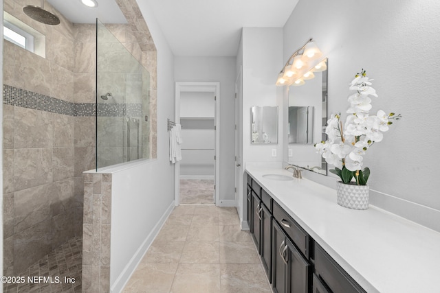 80 Atlas Dr, Saint Augustine, FL 32092 - bathroom featuring vanity, a walk in shower, baseboards, and a walk in closet