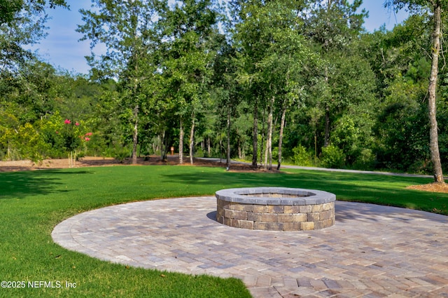 80 Atlas Dr, Saint Augustine, FL 32092 - view of patio with an outdoor fire pit and view of wooded area