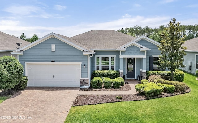 33 Crown Colony Rd, Saint Augustine, FL 32092 - craftsman inspired home featuring decorative driveway, a garage, roof with shingles, stone siding, and a front yard