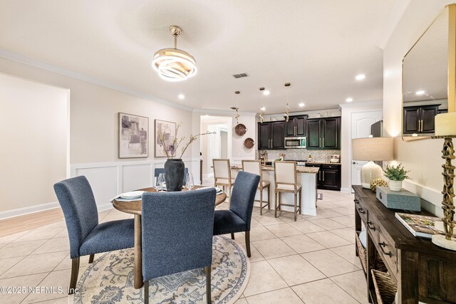 33 Crown Colony Rd, Saint Augustine, FL 32092 - dining area with light tile patterned floors, ornamental molding, recessed lighting, and wainscoting