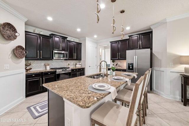 33 Crown Colony Rd, Saint Augustine, FL 32092 - kitchen featuring stainless steel appliances, a sink, ornamental molding, light tile patterned floors, and a breakfast bar
