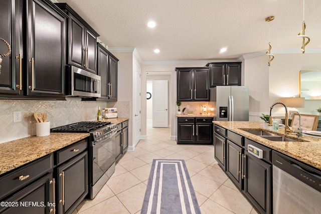 33 Crown Colony Rd, Saint Augustine, FL 32092 - kitchen featuring stainless steel appliances, a sink, ornamental molding, dark cabinets, and light tile patterned flooring