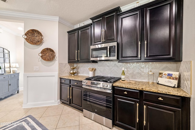 33 Crown Colony Rd, Saint Augustine, FL 32092 - kitchen with appliances with stainless steel finishes, ornamental molding, light stone counters, light tile patterned floors, and decorative backsplash