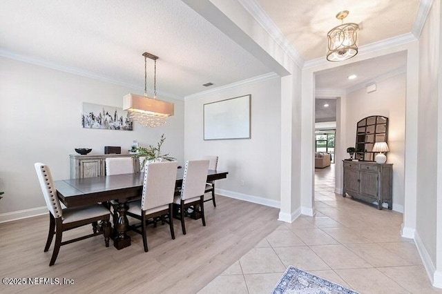 33 Crown Colony Rd, Saint Augustine, FL 32092 - dining room featuring ornamental molding, a chandelier, baseboards, and light tile patterned floors