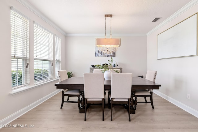 33 Crown Colony Rd, Saint Augustine, FL 32092 - dining area with ornamental molding, baseboards, and light wood-type flooring
