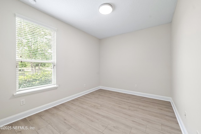 33 Crown Colony Rd, Saint Augustine, FL 32092 - empty room with healthy amount of natural light, light wood-style flooring, and baseboards