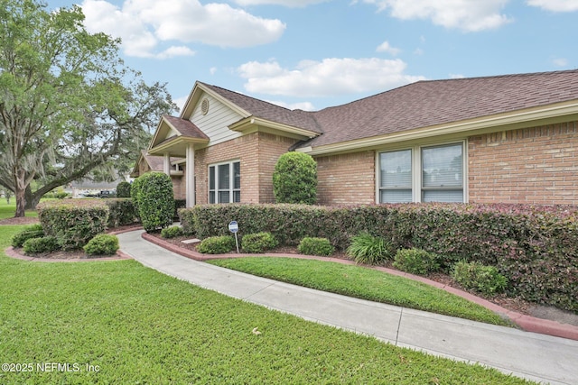 1816 Lakedge Dr, Middleburg, FL 32068 - view of front of home featuring brick siding, a front yard, and roof with shingles