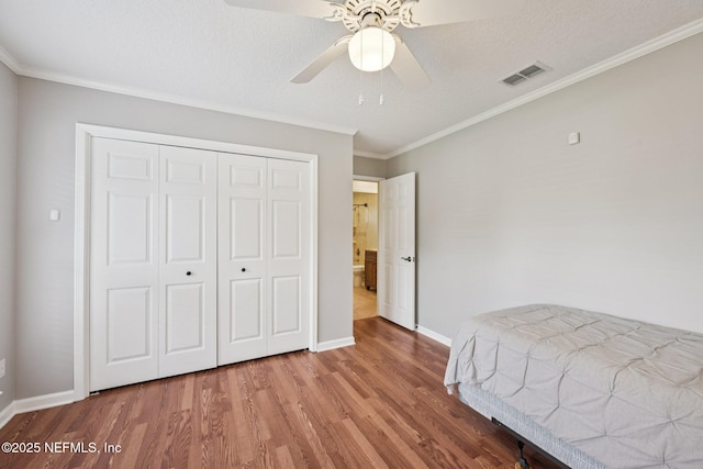 1816 Lakedge Dr, Middleburg, FL 32068 - bedroom with wood finished floors, baseboards, a closet, ornamental molding, and ceiling fan