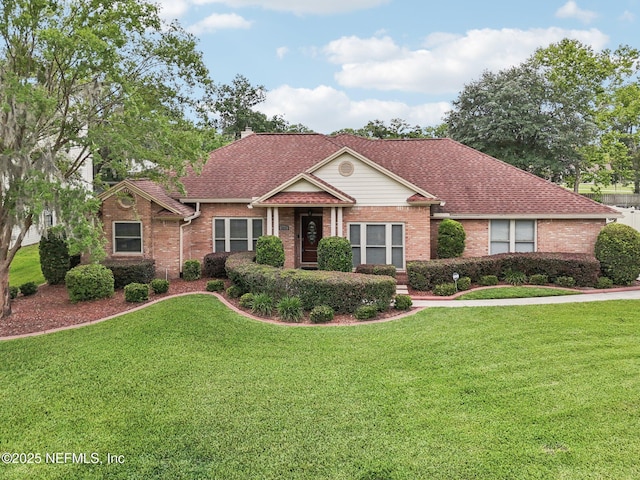 1816 Lakedge Dr, Middleburg, FL 32068 - view of front of home featuring brick siding, a front lawn, and a shingled roof