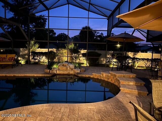 1816 Lakedge Dr, Middleburg, FL 32068 - outdoor pool with glass enclosure and a patio