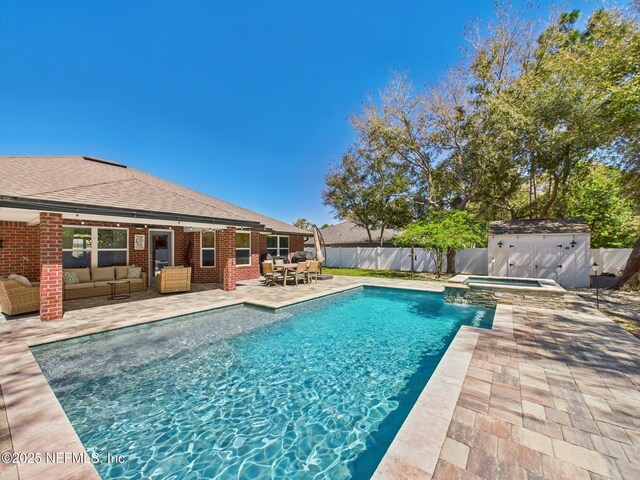 88137 Maybourne Rd, Yulee, FL 32097 - view of pool featuring an outdoor living space, a fenced backyard, a patio area, and a pool with connected hot tub