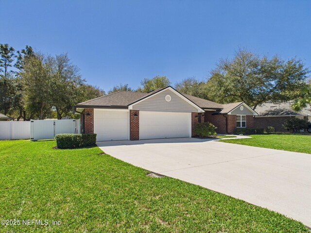 88137 Maybourne Rd, Yulee, FL 32097 - ranch-style home with an attached garage, driveway, and brick siding