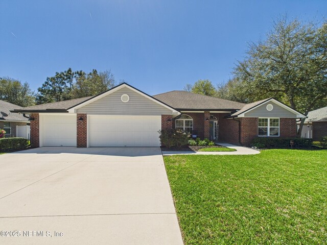 88137 Maybourne Rd, Yulee, FL 32097 - single story home featuring an attached garage, driveway, brick siding, and a front lawn