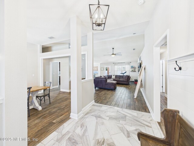 88137 Maybourne Rd, Yulee, FL 32097 - entryway with a chandelier, ceiling fan, baseboards, and wood finished floors