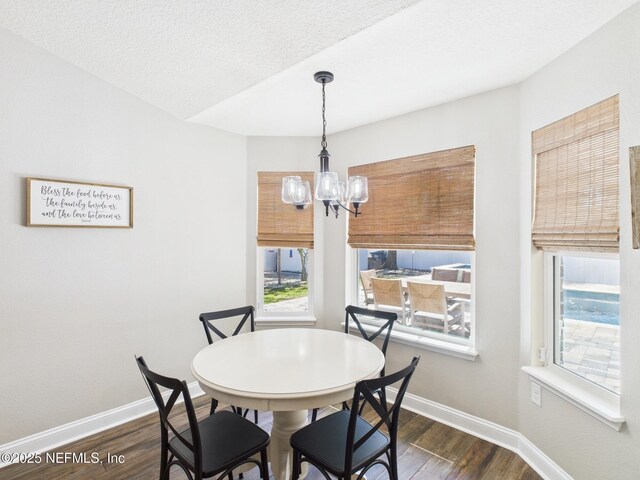 88137 Maybourne Rd, Yulee, FL 32097 - dining room with dark wood-style floors, a chandelier, and baseboards
