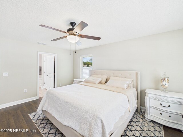 88137 Maybourne Rd, Yulee, FL 32097 - bedroom featuring dark wood-style flooring, baseboards, ensuite bath, and a ceiling fan