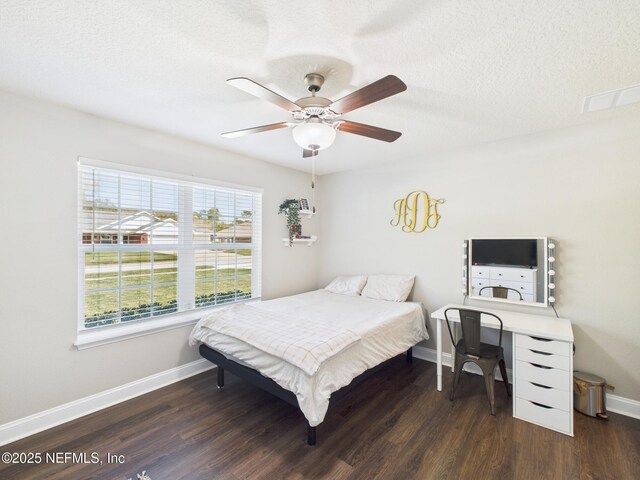 88137 Maybourne Rd, Yulee, FL 32097 - bedroom with wood finished floors, baseboards, a textured ceiling, and a ceiling fan