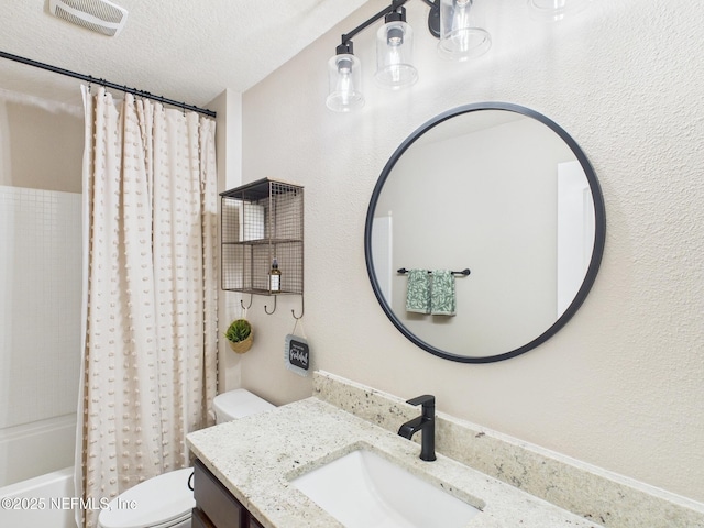 88137 Maybourne Rd, Yulee, FL 32097 - full bathroom featuring toilet, vanity, shower / tub combo, and a textured ceiling