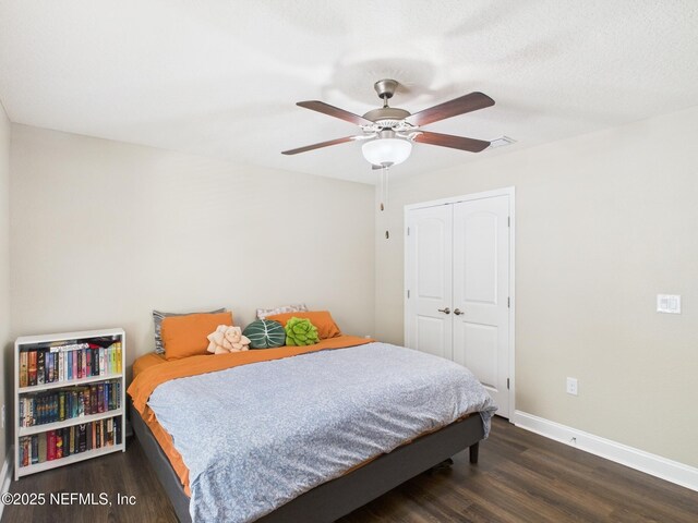 88137 Maybourne Rd, Yulee, FL 32097 - bedroom featuring dark wood-type flooring, baseboards, a closet, and ceiling fan