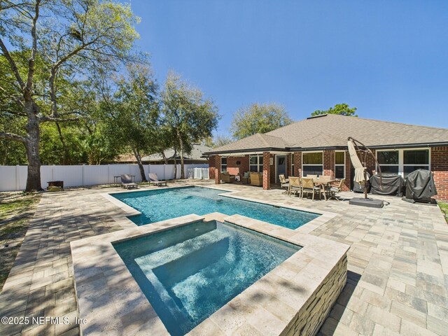 88137 Maybourne Rd, Yulee, FL 32097 - view of pool featuring a fenced backyard, a patio area, a pool with connected hot tub, and outdoor dining area