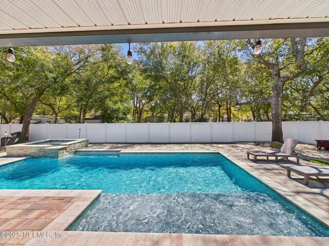 88137 Maybourne Rd, Yulee, FL 32097 - view of swimming pool featuring a fenced backyard, a pool with connected hot tub, and a patio