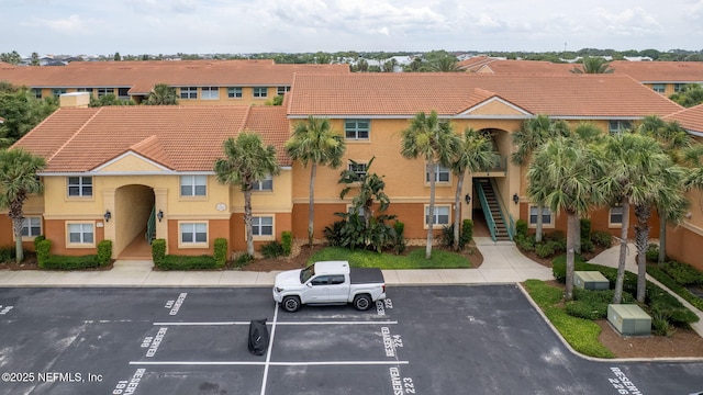 104 Laguna Villas Blvd Unit F33, Jacksonville Beach, FL 32250 - view of property with uncovered parking and stairs