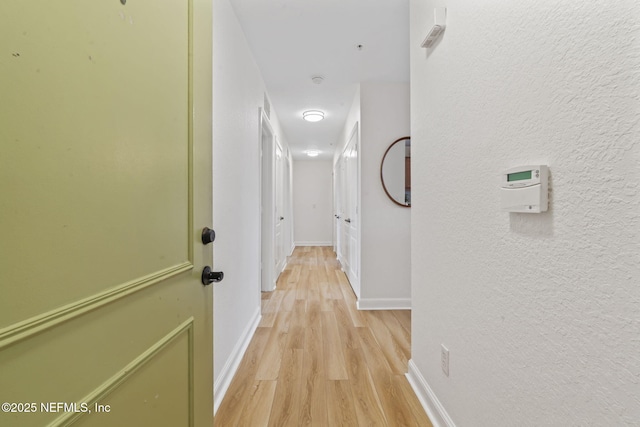 104 Laguna Villas Blvd Unit F33, Jacksonville Beach, FL 32250 - corridor with light wood-style floors, baseboards, and a textured wall