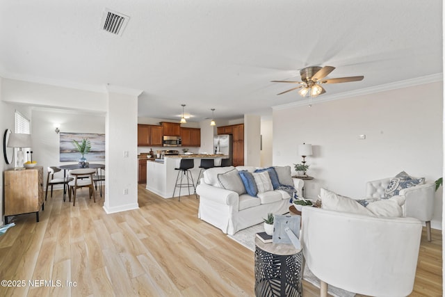104 Laguna Villas Blvd Unit F33, Jacksonville Beach, FL 32250 - living area with ceiling fan, ornamental molding, and light wood-style flooring