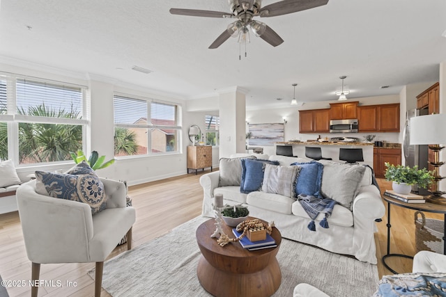 104 Laguna Villas Blvd Unit F33, Jacksonville Beach, FL 32250 - living room with light wood-style flooring, crown molding, baseboards, and a ceiling fan