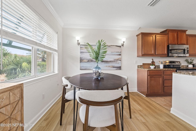 104 Laguna Villas Blvd Unit F33, Jacksonville Beach, FL 32250 - dining area featuring light wood-style flooring, crown molding, and baseboards