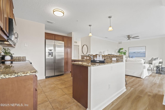 104 Laguna Villas Blvd Unit F33, Jacksonville Beach, FL 32250 - kitchen with stainless steel appliances, a ceiling fan, ornamental molding, hanging light fixtures, and light stone countertops