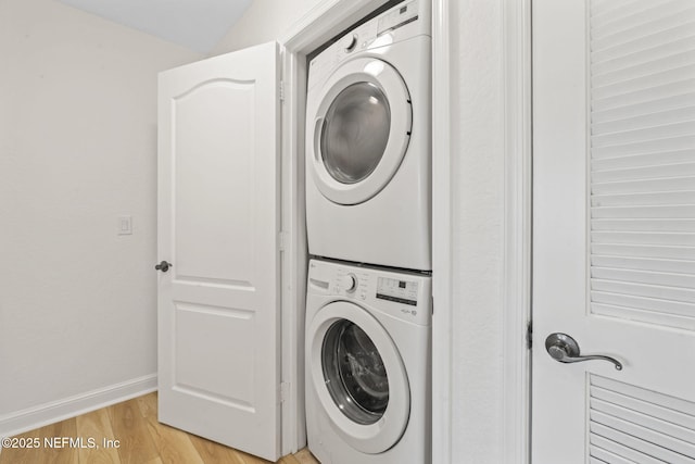 104 Laguna Villas Blvd Unit F33, Jacksonville Beach, FL 32250 - laundry area with stacked washer / dryer, light wood-style floors, and baseboards