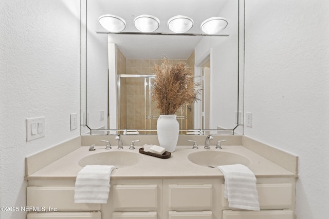 104 Laguna Villas Blvd Unit F33, Jacksonville Beach, FL 32250 - bathroom with a textured wall, double vanity, and a stall shower