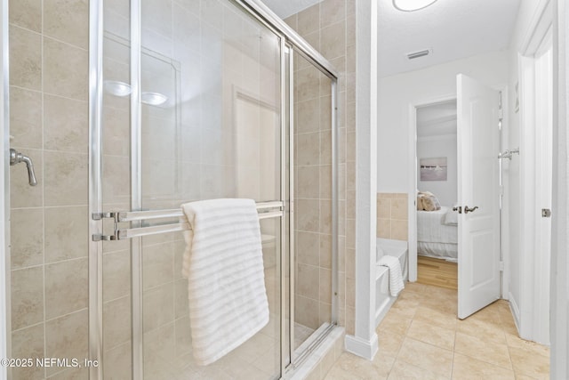 104 Laguna Villas Blvd Unit F33, Jacksonville Beach, FL 32250 - ensuite bathroom featuring a shower stall, tile patterned flooring, and tile walls