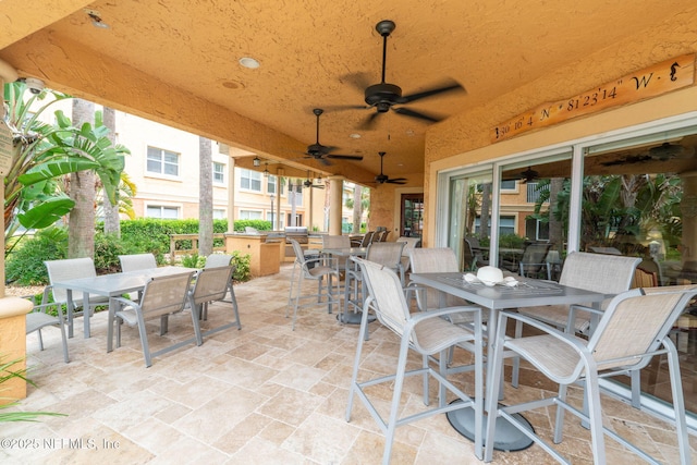 104 Laguna Villas Blvd Unit F33, Jacksonville Beach, FL 32250 - view of patio / terrace featuring outdoor dining area, an outdoor kitchen, and a ceiling fan