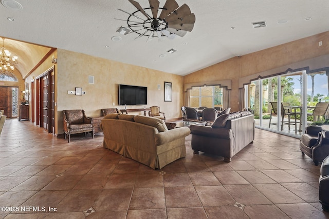 104 Laguna Villas Blvd Unit F33, Jacksonville Beach, FL 32250 - living room with a chandelier, ceiling fan, a textured ceiling, and high vaulted ceiling