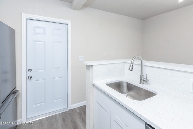 736 W St, Jacksonville, FL 32204 - washroom featuring a sink, light wood finished floors, and baseboards