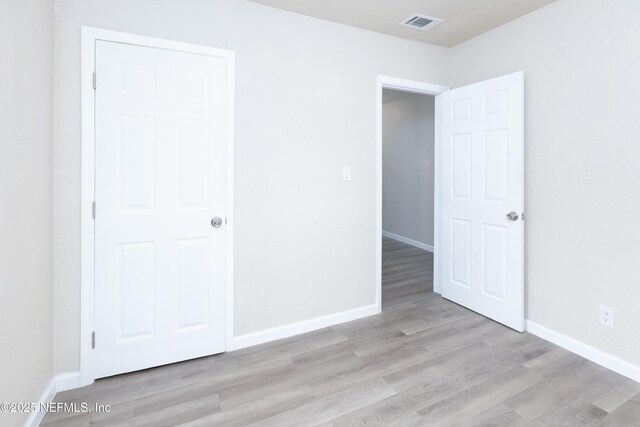 736 W St, Jacksonville, FL 32204 - unfurnished bedroom with wood finished floors and baseboards