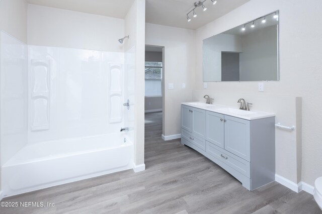 736 W St, Jacksonville, FL 32204 - full bathroom featuring shower / bathtub combination, baseboards, double vanity, and wood finished floors