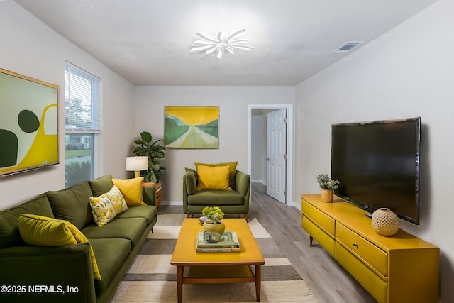 736 W St, Jacksonville, FL 32204 - living room with light wood-style floors and baseboards
