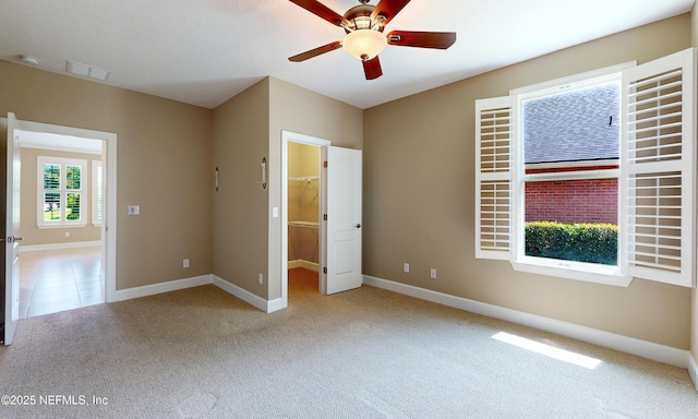3653 Oglebay Dr, Green Cove Springs, FL 32043 - unfurnished bedroom with light colored carpet, baseboards, a spacious closet, and a ceiling fan